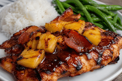 Grilled pineapple BBQ chicken topped with crispy beef bacon and caramelized pineapple chunks, served with rice and green beans for a quick sweet smoky dinner.