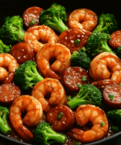 Juicy honey garlic shrimp sautéed in a sticky sweet and savory glaze, garnished with sesame seeds and green onions—served over rice for a quick, high-protein seafood meal.