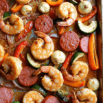 Honey Garlic Shrimp & Sausage Sheet Pan with roasted vegetables on a rustic baking tray