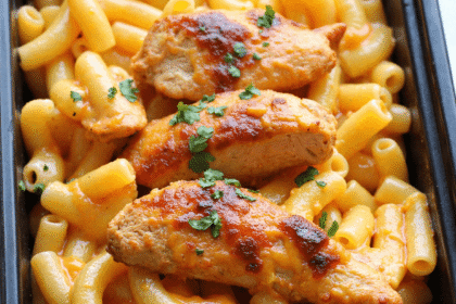 Meal prep container filled with high protein mac and cheese and grilled BBQ chicken breast