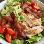 Keto BLT chicken salad with crispy bacon, grilled chicken, avocado, mashed avocado dressing, and cherry tomatoes