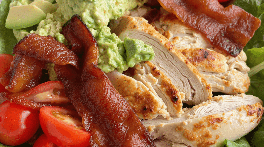 Keto BLT chicken salad with crispy bacon, grilled chicken, avocado, mashed avocado dressing, and cherry tomatoes