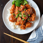 Sweet chili chicken served over steamed white rice with broccoli and sesame seeds