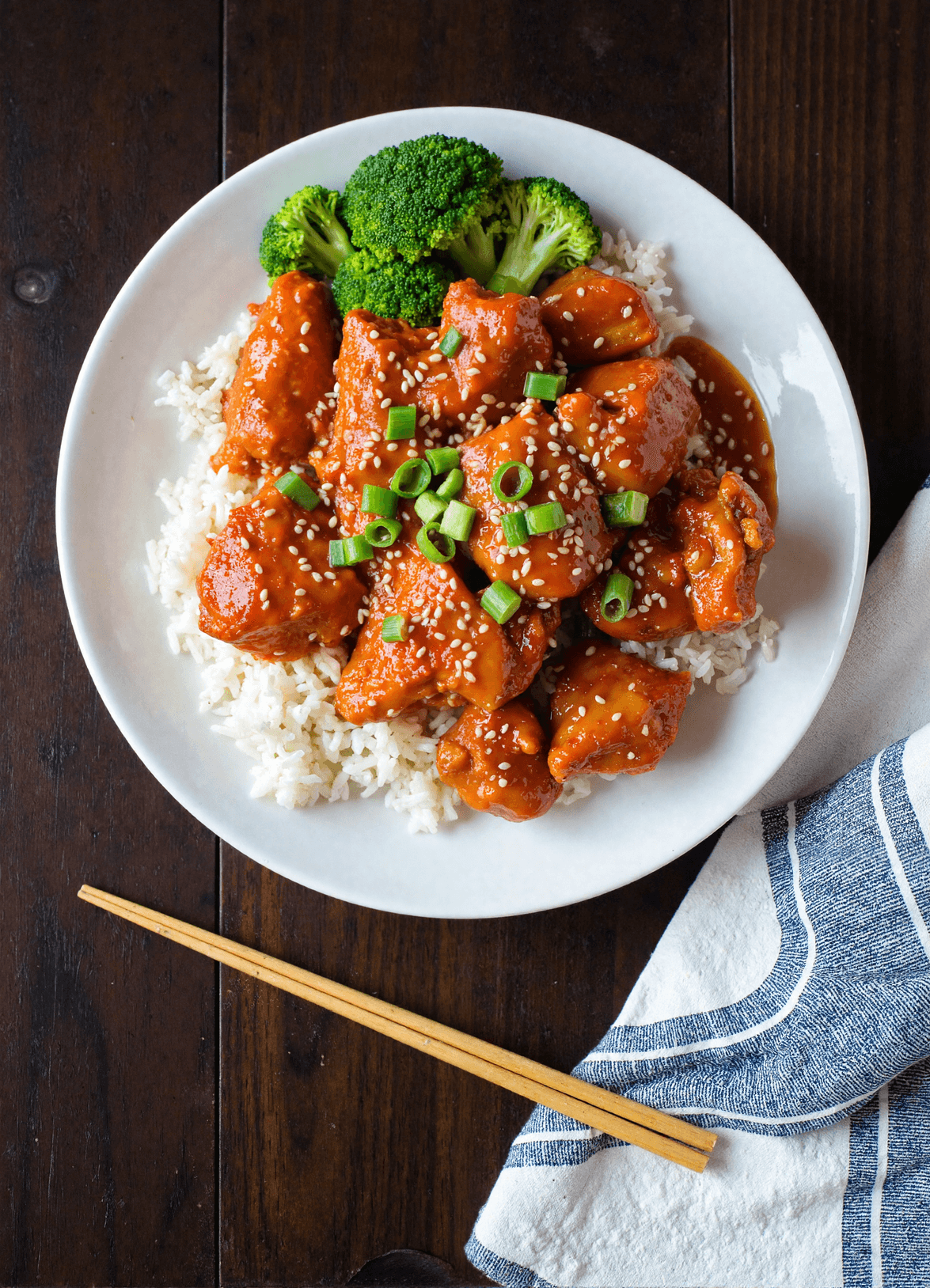 Sweet chili chicken served over steamed white rice with broccoli and sesame seeds