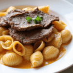 Tender slices of seared steak on top of creamy paprika pasta shells coated in garlic cream sauce.