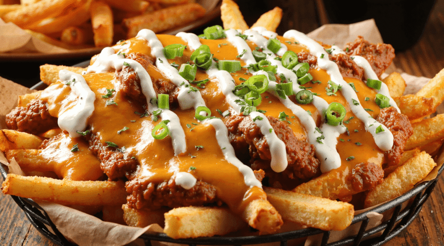 Cajun voodoo fries topped with spicy chicken, melted cheese, creamy ranch, and green onions.