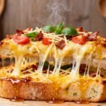 Cheesy honey garlic bread pizza with bacon, tomato, parmesan, basil, and honey dripping over toasted bread slices.