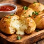 Pull-apart garlic bread balls stuffed with melted mozzarella and garnished with fresh parsley.