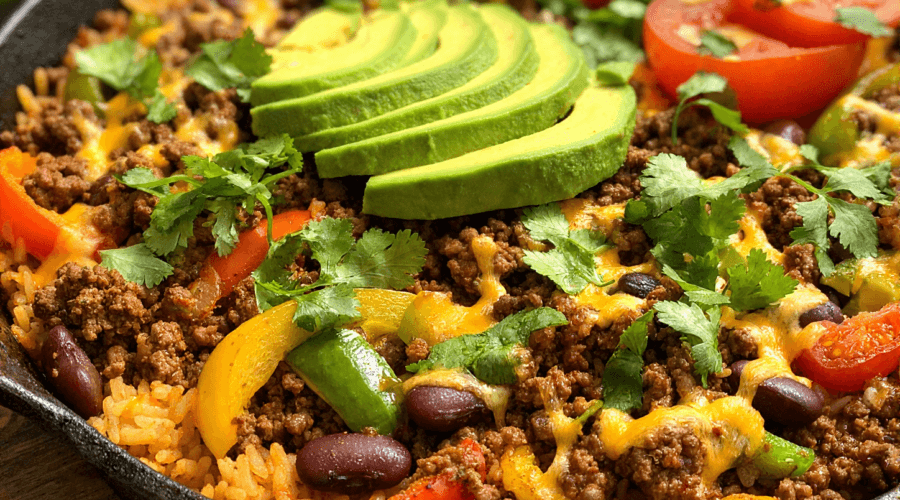 High-protein beef burrito skillet with ground beef rice beans cheese and avocado
