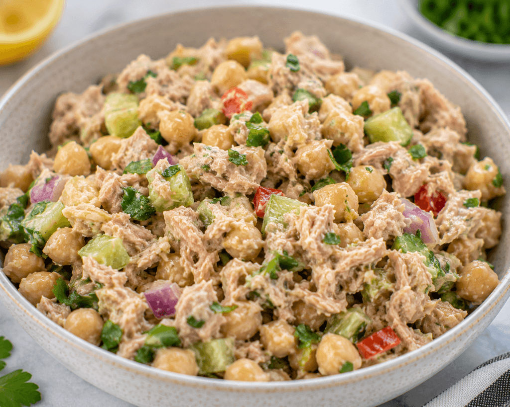 Protein-Packed Tuna Garbanzo Bean Salad with tuna, chickpeas, cucumber, red onion, herbs, and fresh vegetables in an easy no-cook high-protein salad bowl.