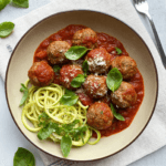 Top view of turkey meatball marinara with basil and parmesan in tomato sauce