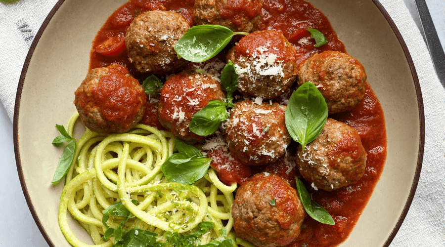 Top view of turkey meatball marinara with basil and parmesan in tomato sauce